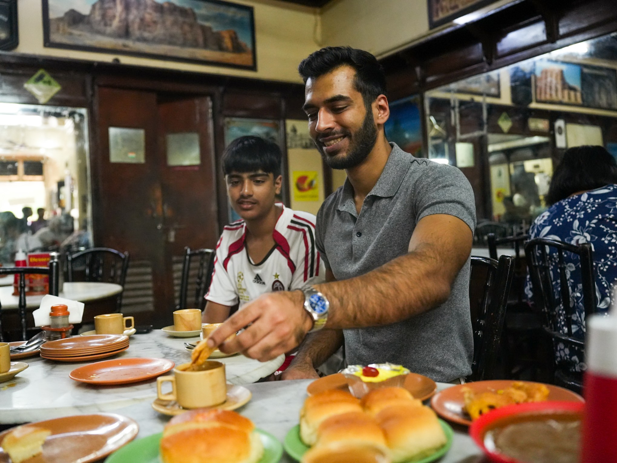 a man sitting at a table eating food