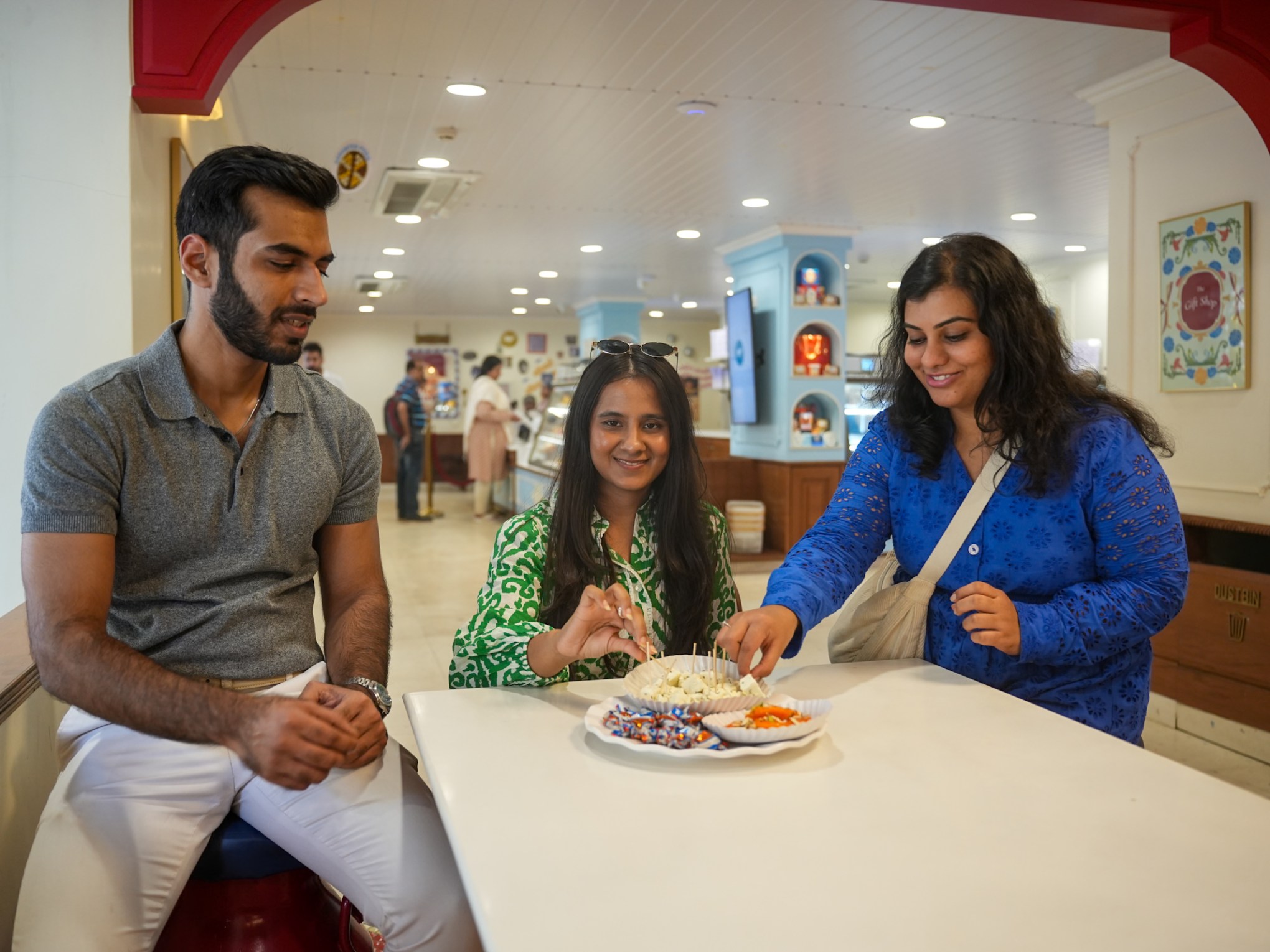 a group of people sitting at a table with food