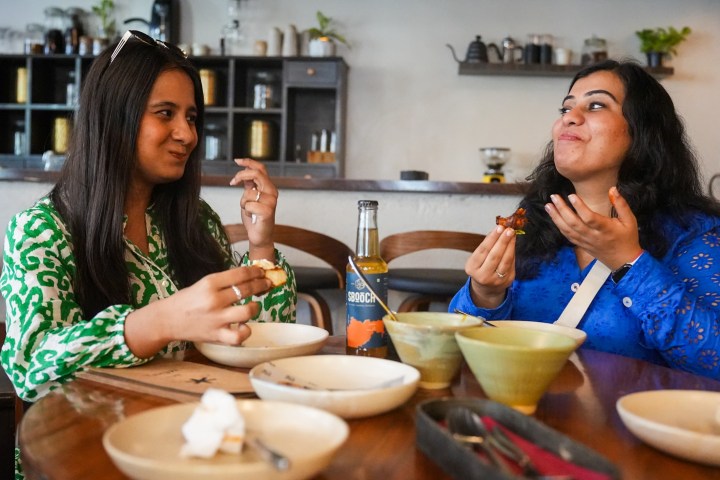 a woman sitting at a table eating food