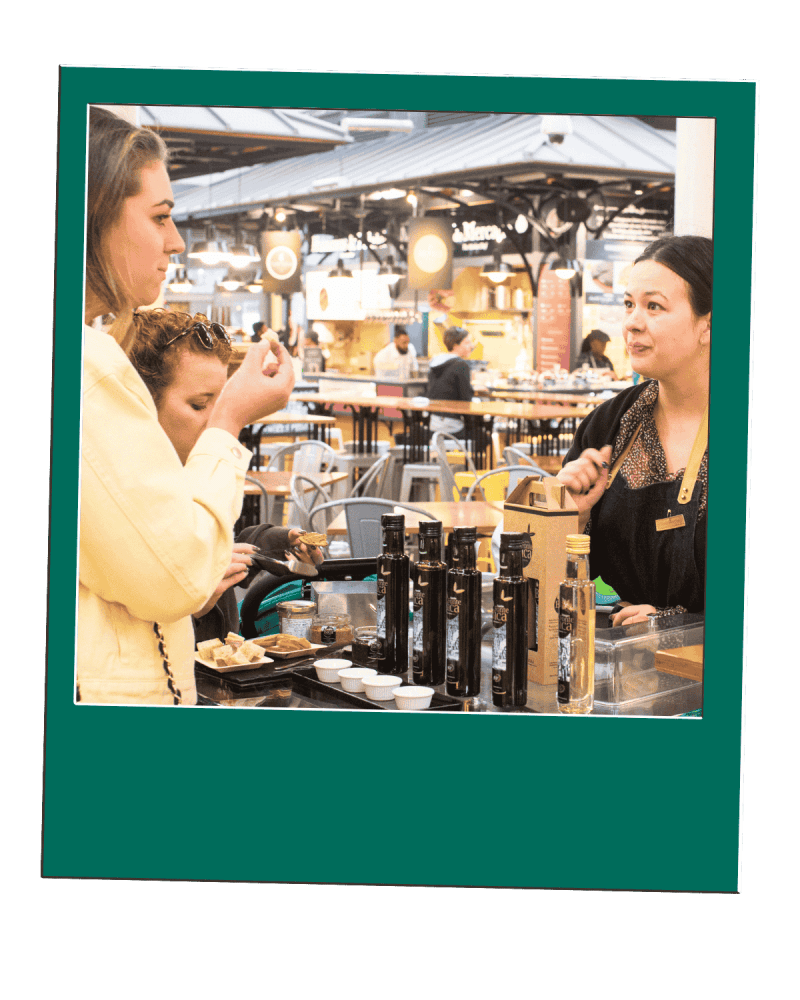 A Women Tasting Olive Oil in a Lisbon Market at the Morning Food Lover Tour A Women Tasting Olive Oil in a Lisbon Market at the Morning Food Lover Tour