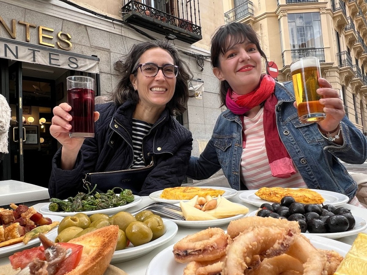 a group of people sitting at a table with a plate of food