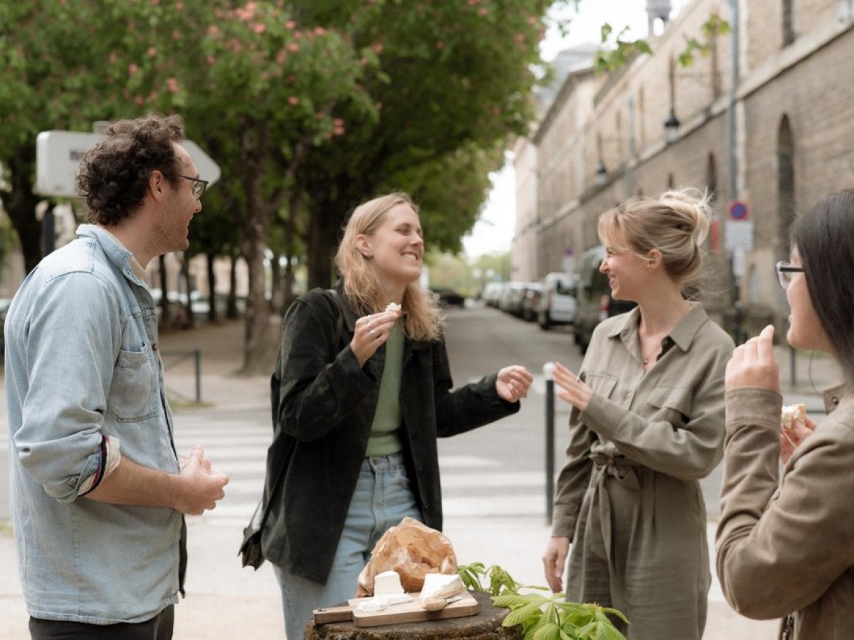 a group of people standing on a sidewalk
