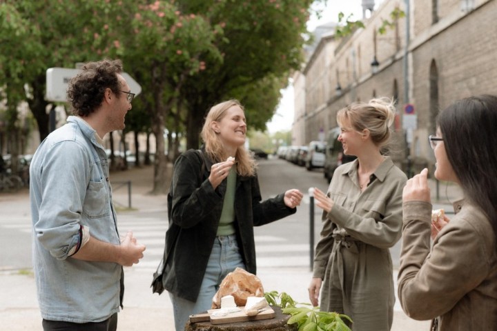 a group of people standing on a sidewalk