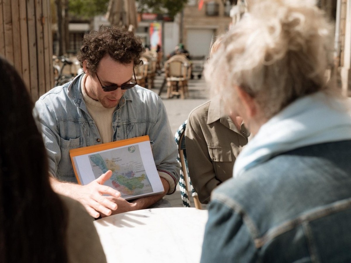 a group of people looking at a laptop