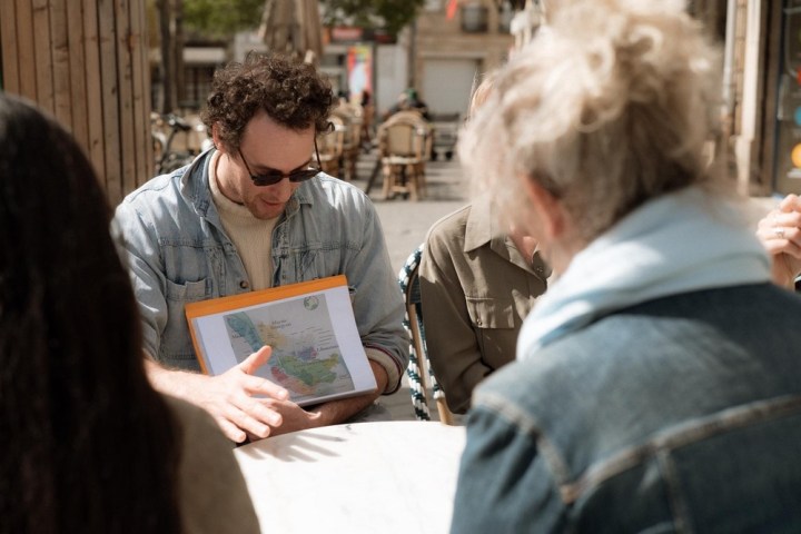 a group of people looking at a laptop