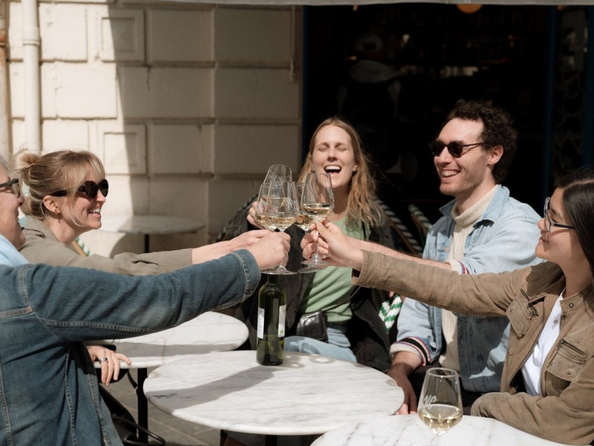 a group of people holding wine glasses