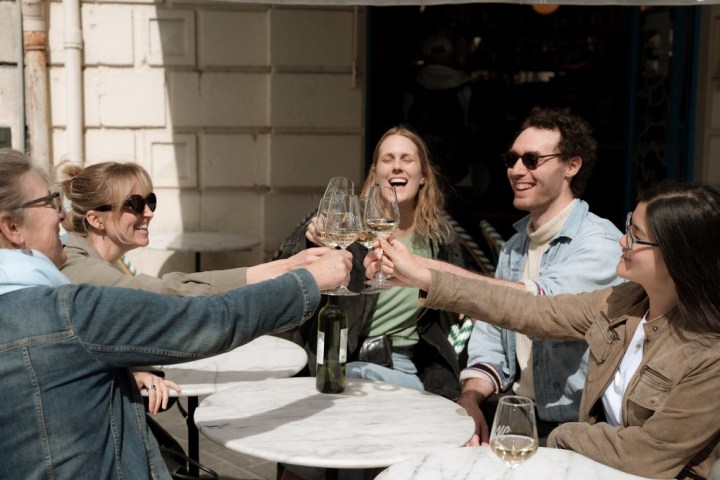 a group of people holding wine glasses