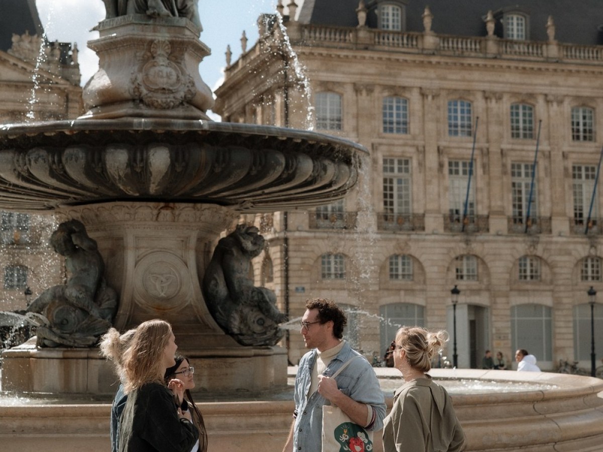 a group of people walking in front of a building