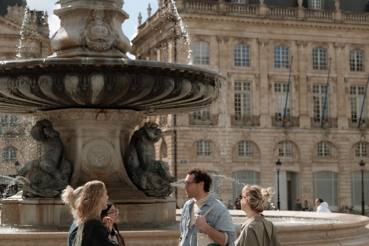 a group of people walking in front of a building