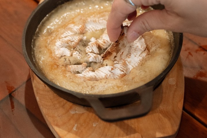 a bowl of food on a wooden table
