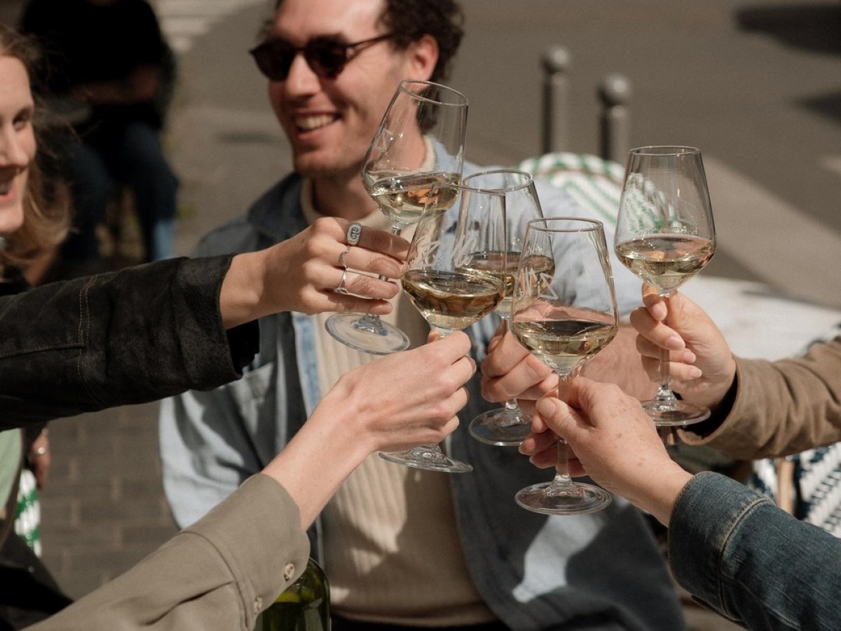 a group of people sitting at a table with wine glasses