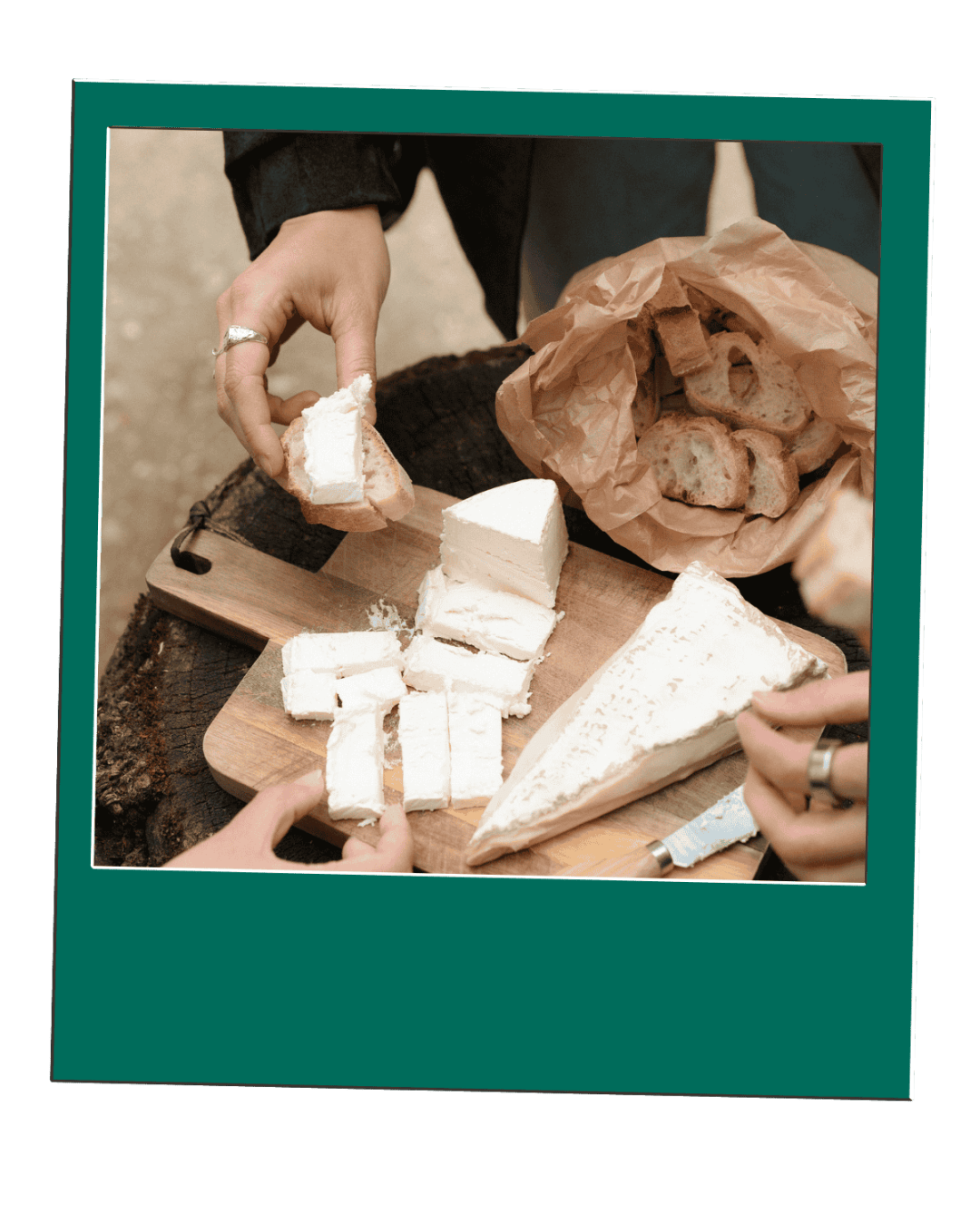 Hands cutting and serving cheese slices on a board with a bag of bread nearby.